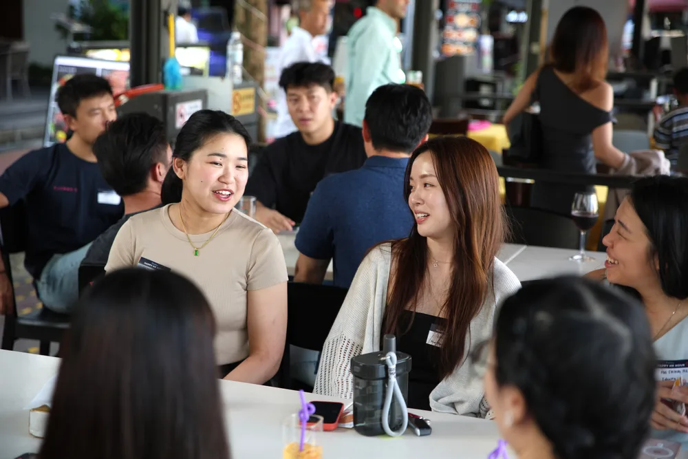 Attendees exchanging ideas around a table at a StaffAny Singapore gathering