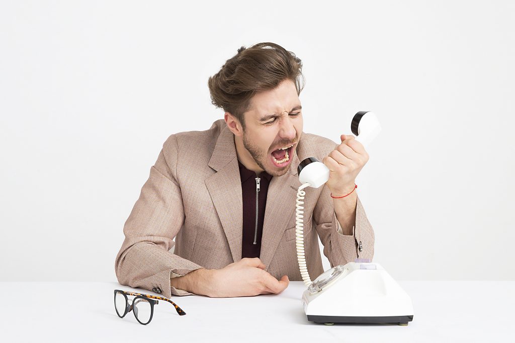 frustrated boss shouting into the phone