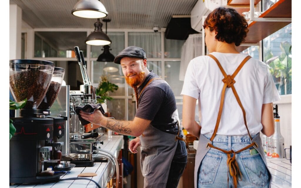 two baristas working in a cafe